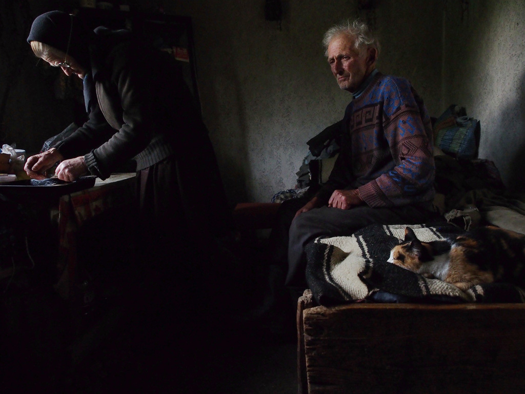 he was waiting on the bed, lost in thoughts, while his wife was preparing the bread to be blessed for the orthodox Eucharist.